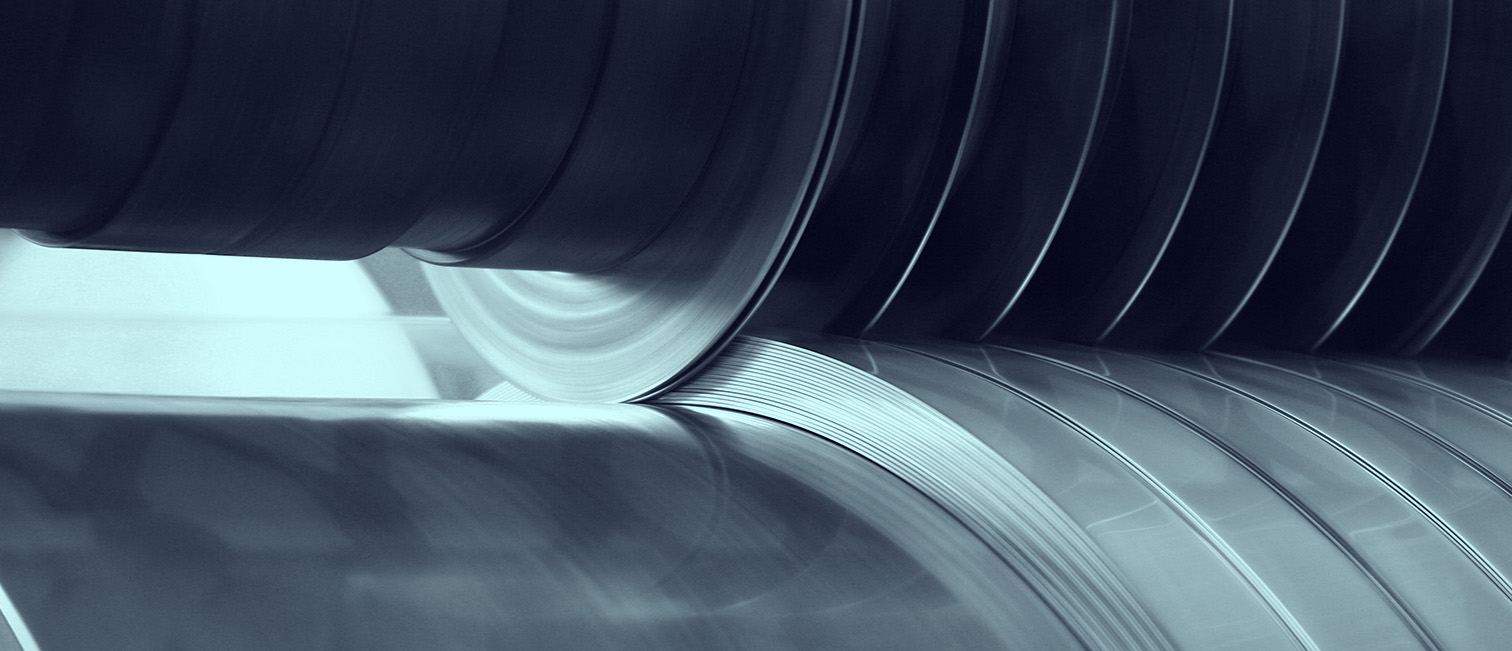Precision-slit stainless steel coil passing through industrial rollers